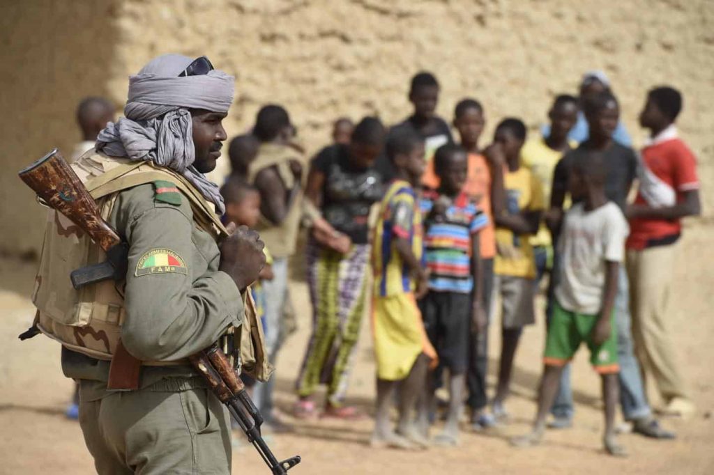 A soldier of the Malian Armed Forces on patrol, likely watching for JNIM