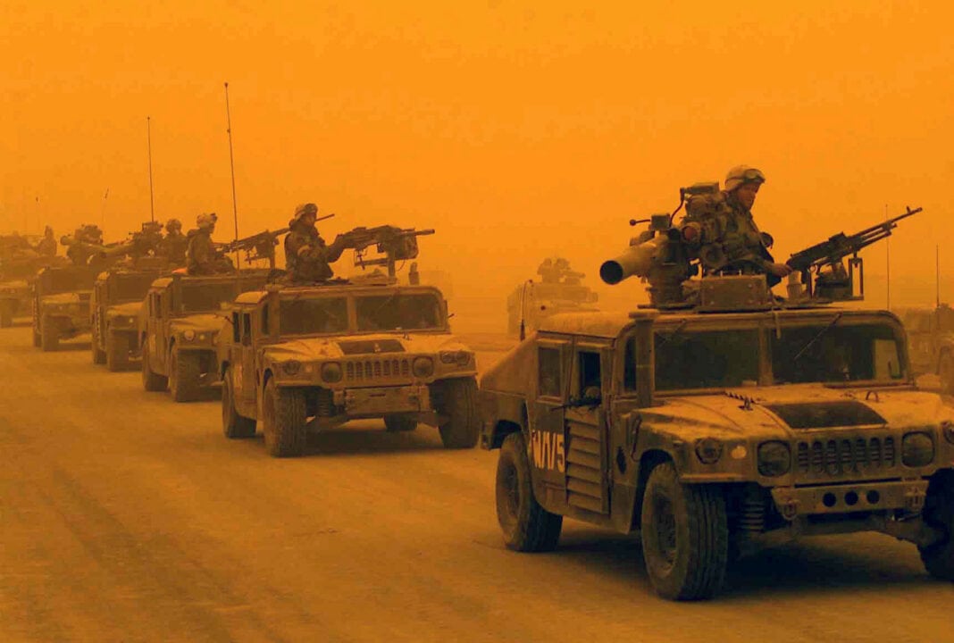 A convoy of US Marine Corps (USMC) High-Mobility Multipurpose Wheeled Vehicles (HMMVW), assigned to D/Company, 1st Light Armored Reconnaissance Battalion, 1st Marines Division, arrives in Northern Iraq, during a sandstorm.