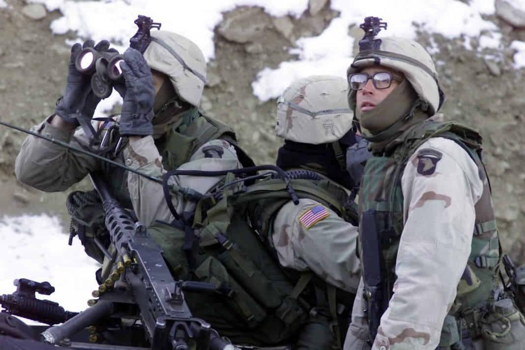 Soldiers from the 1st Battalion, 187th Infantry Regiment, 101st Airborne Division (Air Assault), scan the ridgeline for enemy forces during Operation Anaconda, March 4, 2002.