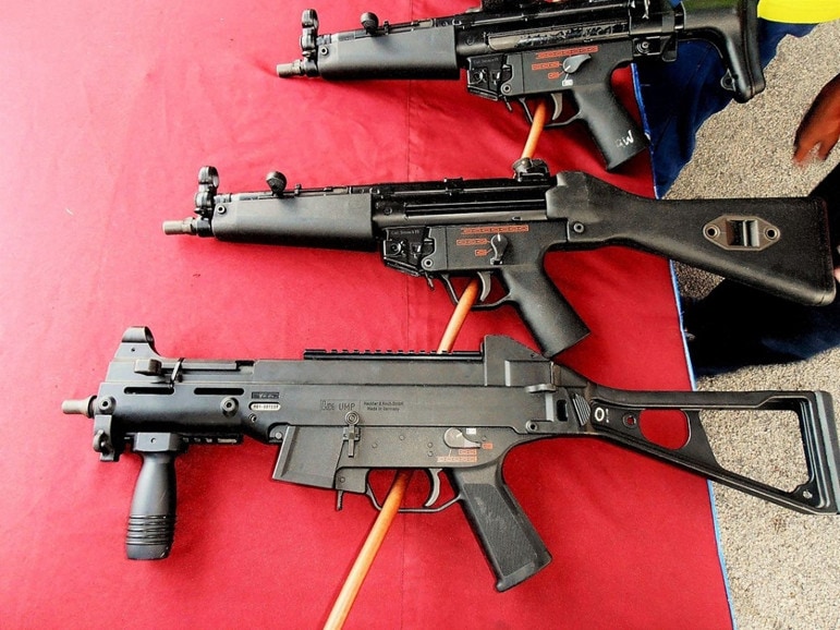 UMP9 on red table with two MP5s.