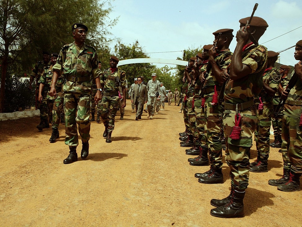 Senegalese troops on parade on a dirt road.