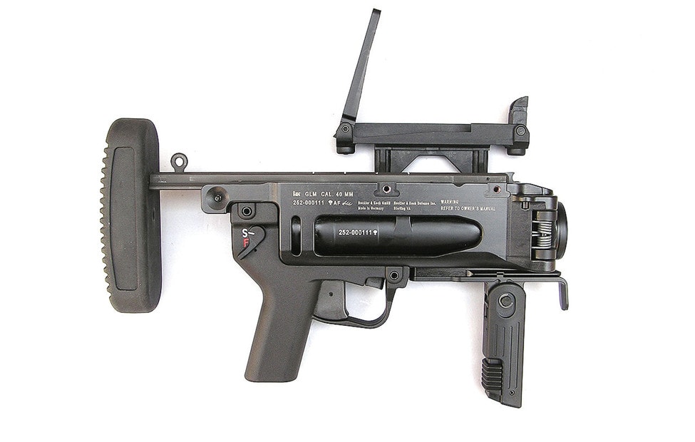 M320 grenade launcher with sights unfolded on white background.