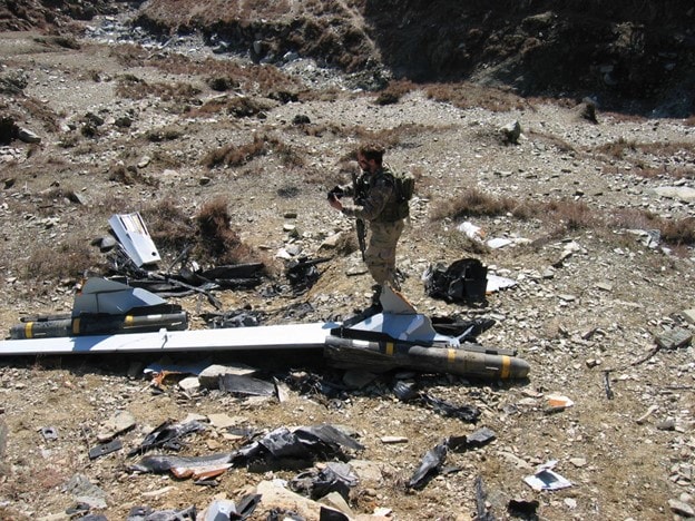 Soldier near the wreckage of an aircraft.