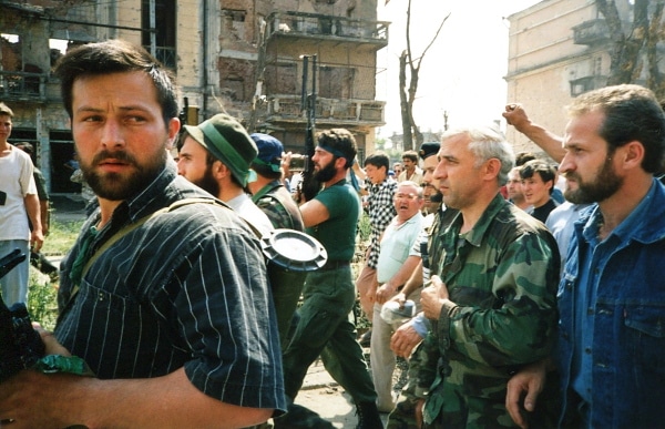 Chechen fighters walking down street.