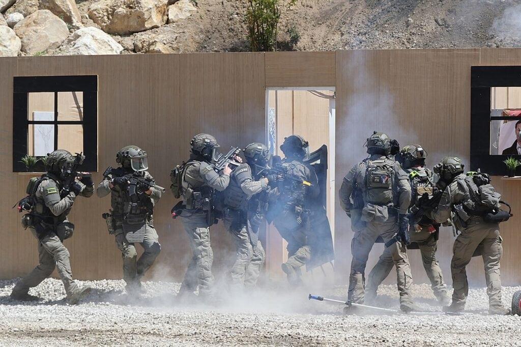 GIGN team kick in the front door to a kill house in training 