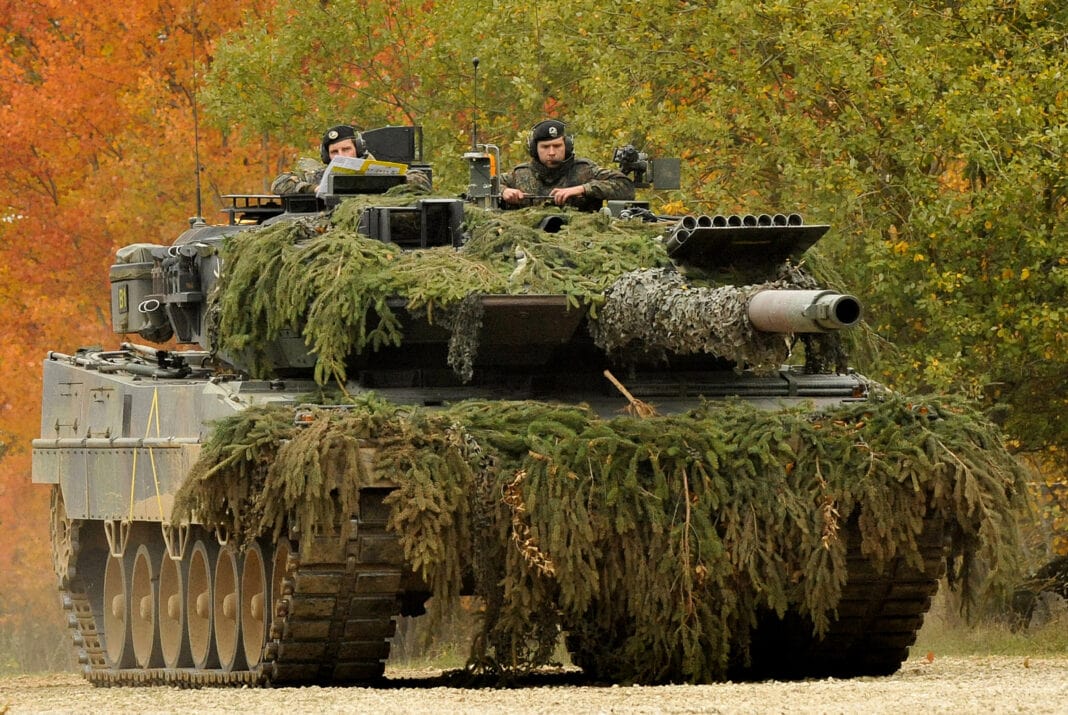 A German Army Leopard II tank, assigned to 104th Panzer Battalion, moves through the Joint Multinational Readiness Center during Saber Junction 2012 in Hohenfels, Germany, Oct. 25. The U.S. Army Europe's exercise Saber Junction trains U.S. personnel and 1800 multinational partners from 18 nations ensuring multinational interoperability and an agile, ready coalition force. (U.S. Army Europe photo by Visual Information Specialist Markus Rauchenberger/released)