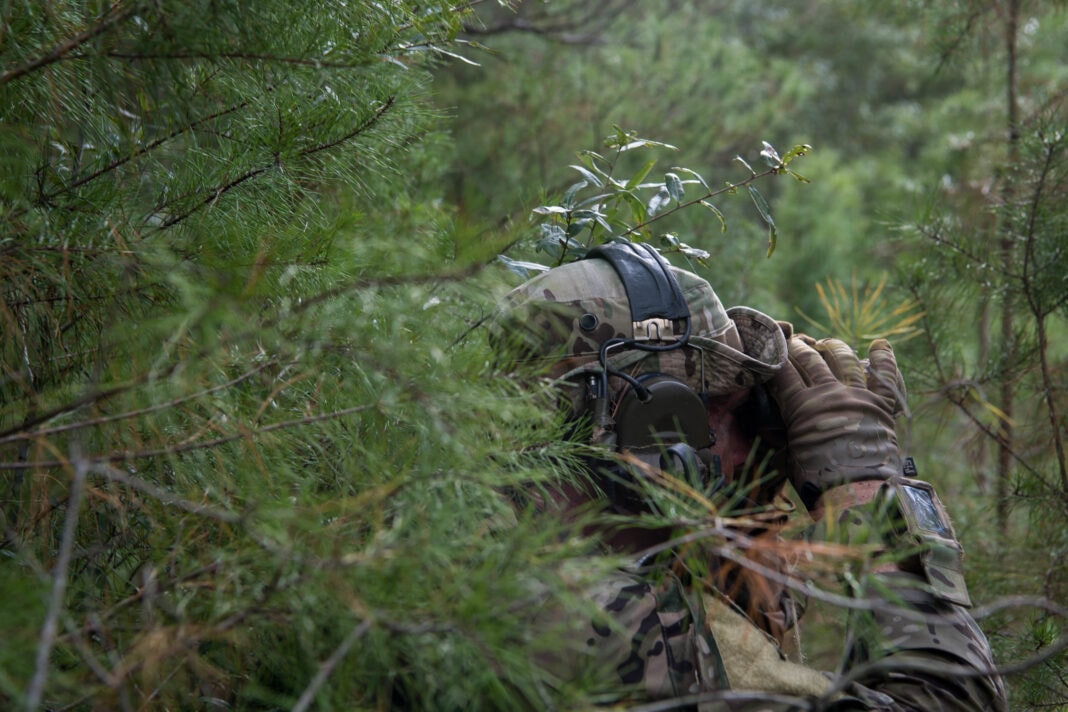 A U.S. Air Force Special Tactics operator looks through binoculars to observe a target during a full mission profile as part of a beta Special Reconnaissance course near Hurlburt Field, Florida, Sept. 25, 2019.