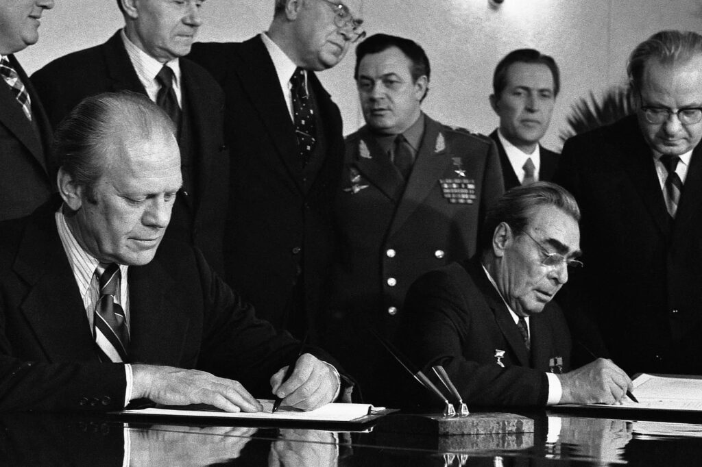 President Gerald R. Ford and General Secretary Leonid Brezhnev at the Vladivostok Summit, signing SALT II on 24 November 1974. SALT II is an arms control framework with dubious lessons for cyber arms control.