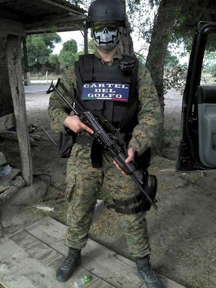 Armed soldier belonging to the Cartel del Golfo posing.