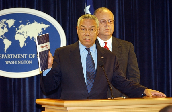Cofer Black standing behind former Secretary of State Colin Powell 