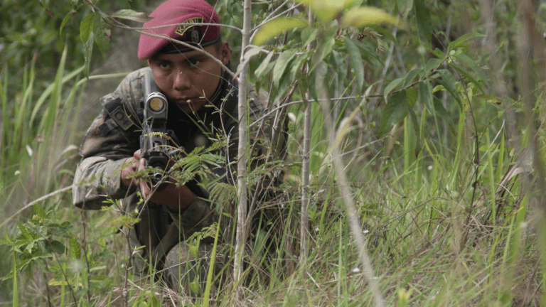 A Guatemalan Army Special Forces or "Kaibil" officer conducts jungle patrol exercise.