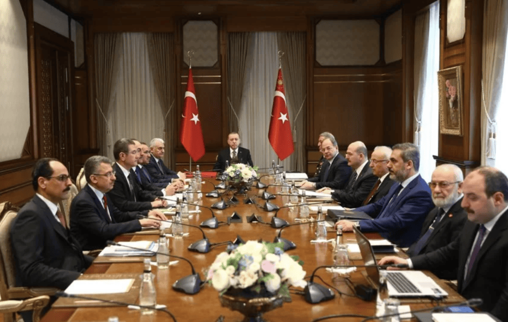 Adnan Tanrıverdi sitting as Turkish chief military adviser at the table of President Erdoğan's closest political circle.