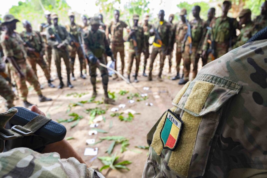 A Beninese platoon lieutenant uses a sand table diagram to discuss squad assignments during Joint Combined Exchange Training