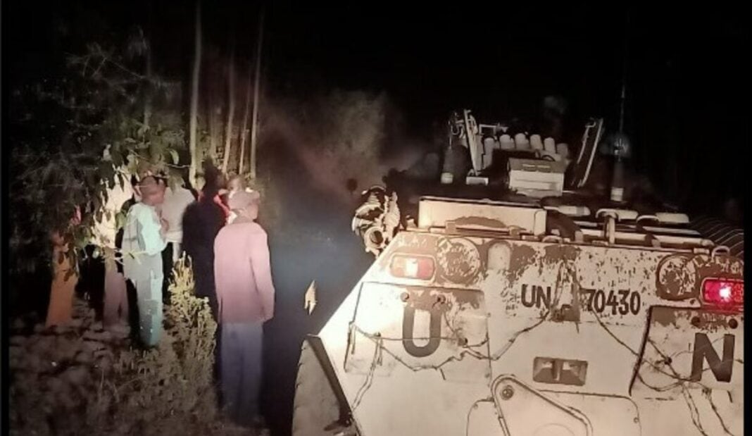 Members of the CODECO militia standing alongside a UN tank.