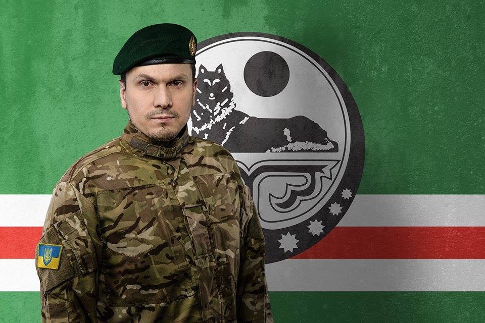 A Picture of Current Dzhokhar Dudayev Battalion Commander Osmayev in front of an Ichkeria flag