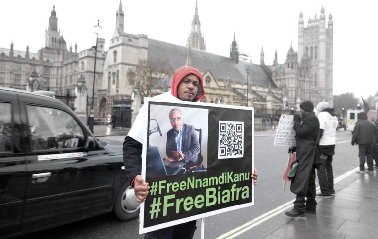 Members of Indigenous People of Biafra (IPOB) protest in London outside the Houses of Parliament. A protester is holding a placard that reads: #Free Biafra #Free Nnamdi Kanu
