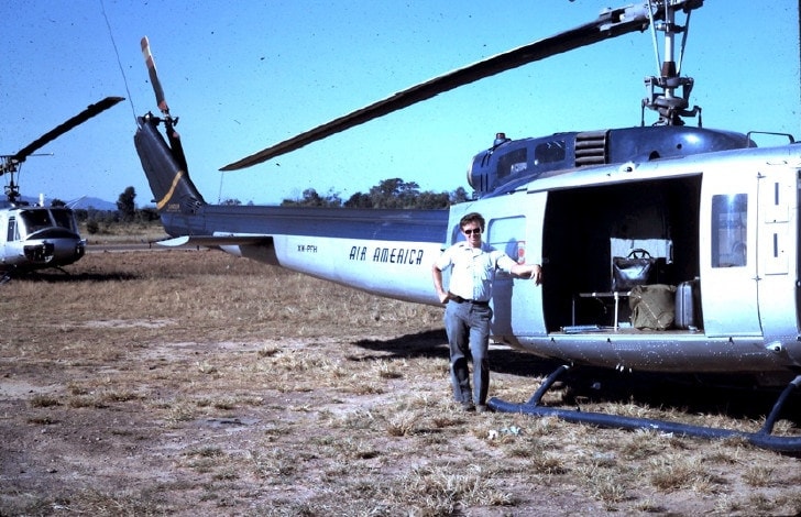 Gary Gentz stands in front of an Air America Bell Huey 204B (sourced from https://www.air-america.org/virtualmuseum-missions.html)
