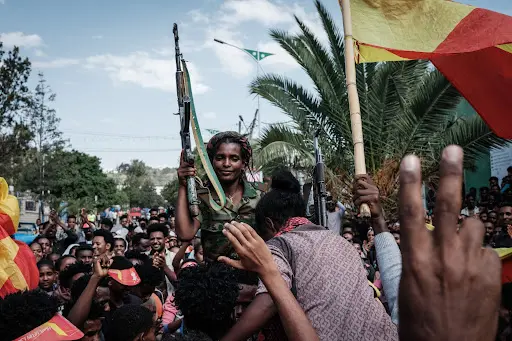 Tigray Defense Force fighters and Tigray flags at a march.