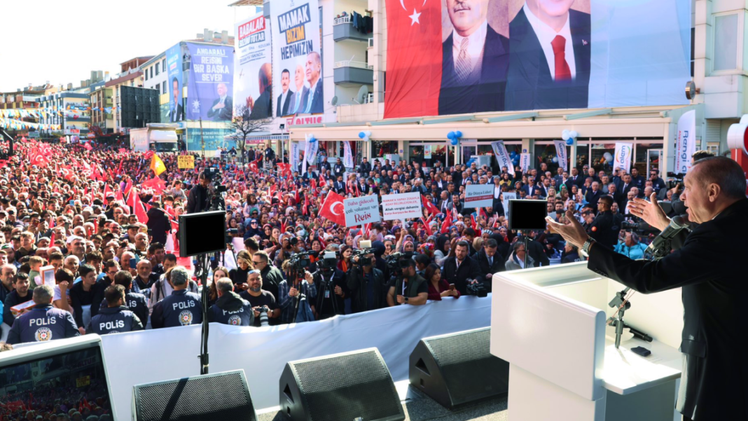 Turkish Prime Minister Recep Tayyip Erdogan greets the crowd during a local election rally organized by the ruling Justice and Development Party (AKP).