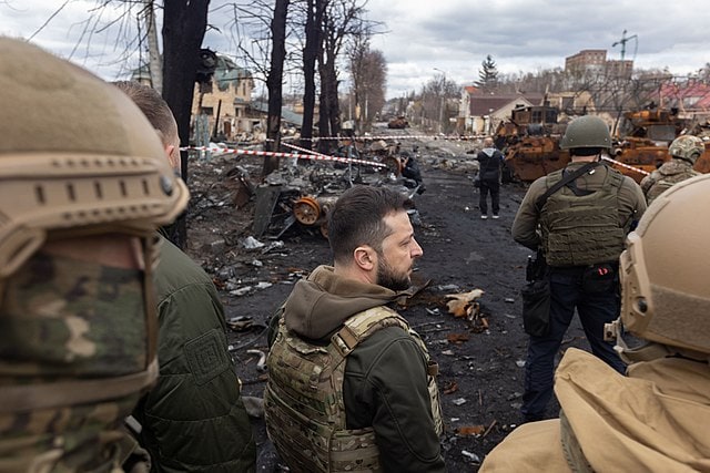 Ukrainian President Zelensky looks over Russian casualties near Bucha. The site was host to a Russian massacre of Ukrainian civilians.
