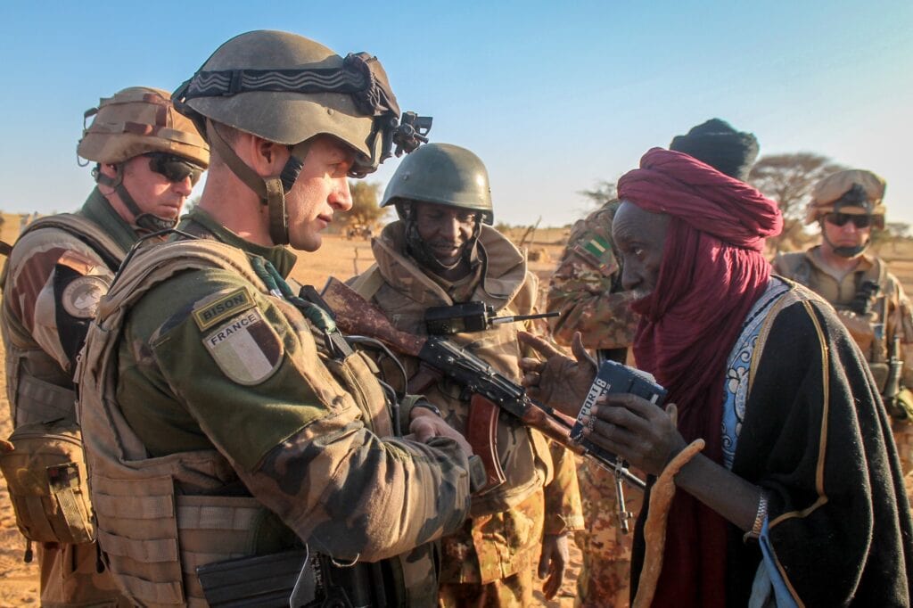 French troops conversing with civilians in the Sahel during Operation Barkhane likely collecting intelligence