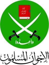 This image depicts the Muslim Brotherhood's official logo. It is white circular emblem featured on a dark green backdrop. Within the emblem, two swords converge with an image of the Qu'ran featured atop. In the central crest, written in Arabic, it reads 'prepare'