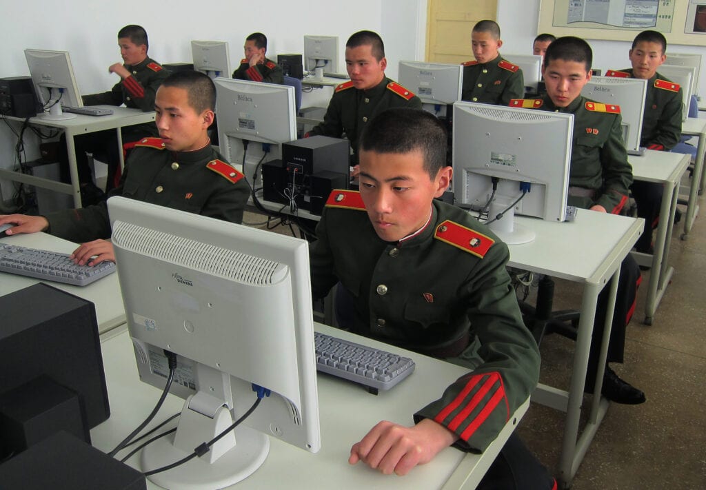 DPRK soldiers working on computers