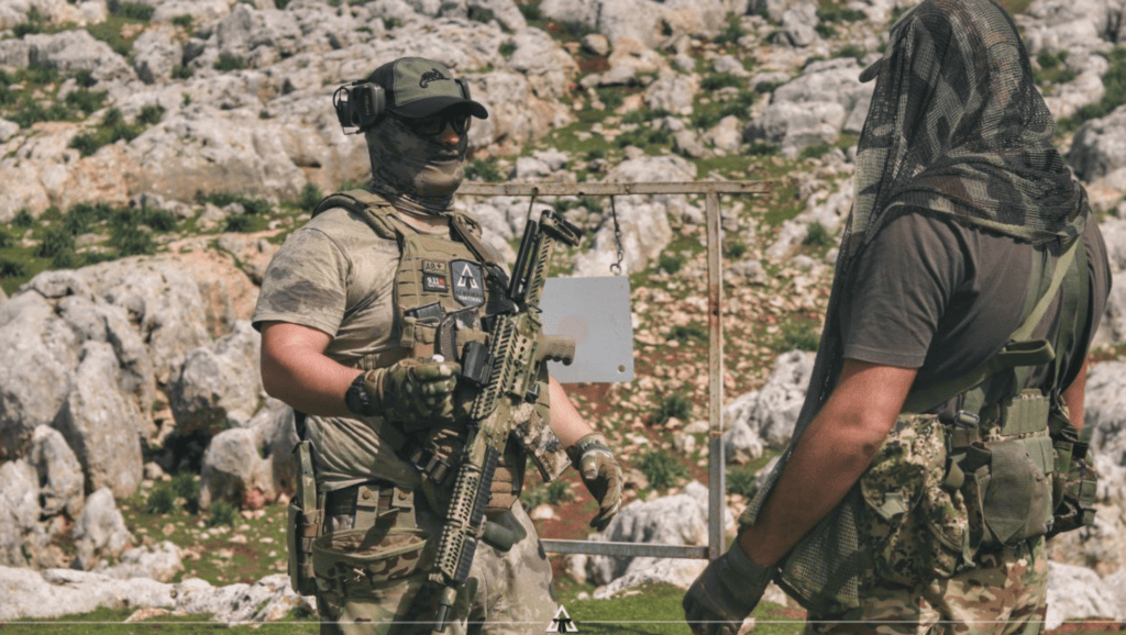 Albanian Tactical (Xhemati Alban sub-group) instructing another fighter on the shooting range.