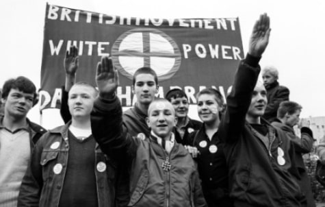 Members of the British Movement hold up a banner with 'White Power' and give Nazi salutes, during a march from Hyde Park, London, to Paddington Recreation Ground in 1980.