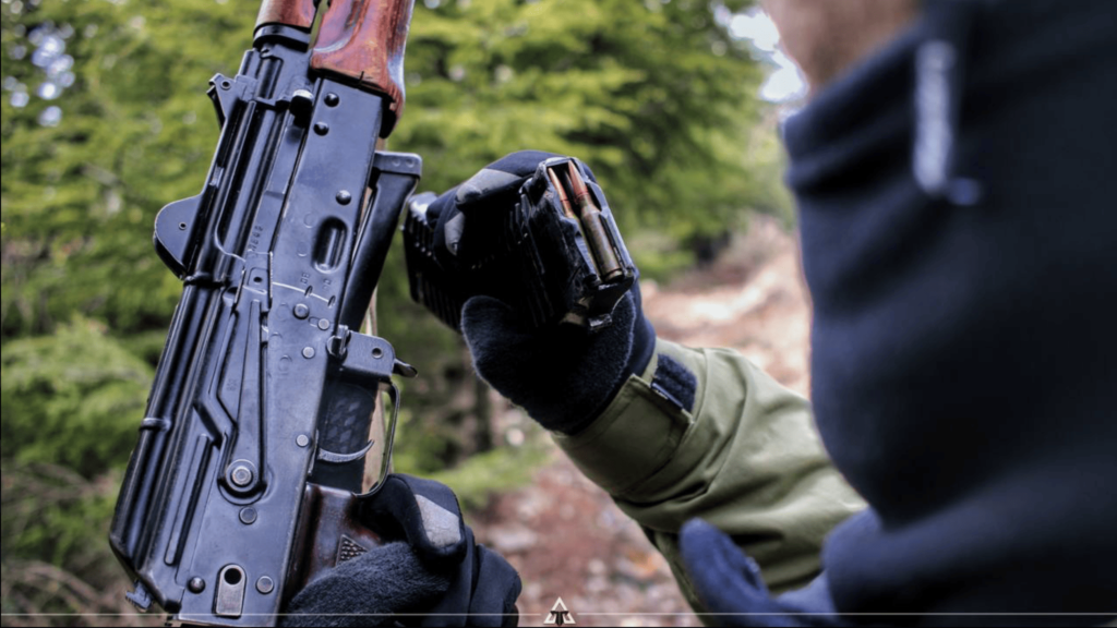 AK-47 and magazine being inspected.