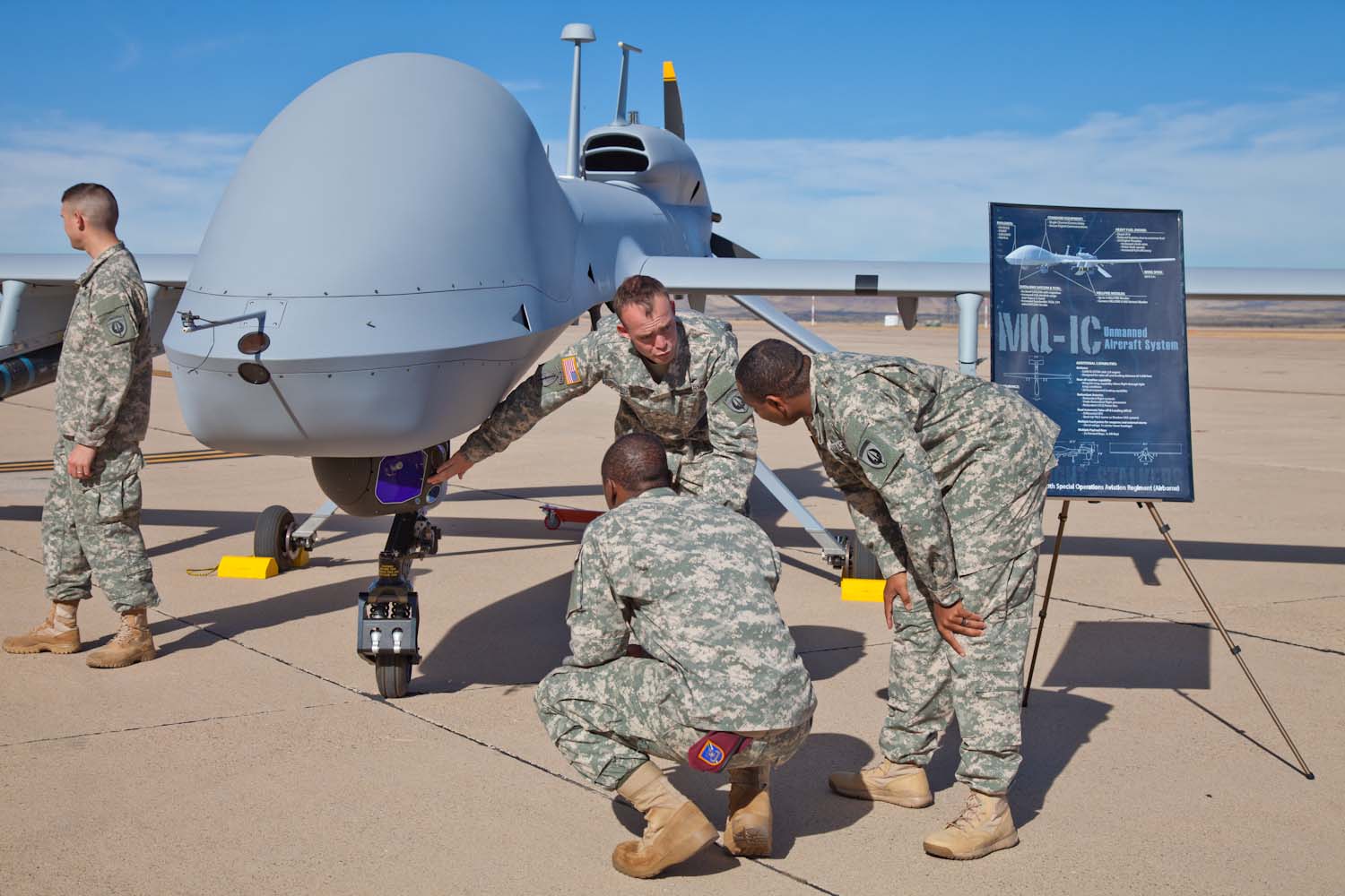 Men in uniform looking at a new drone.