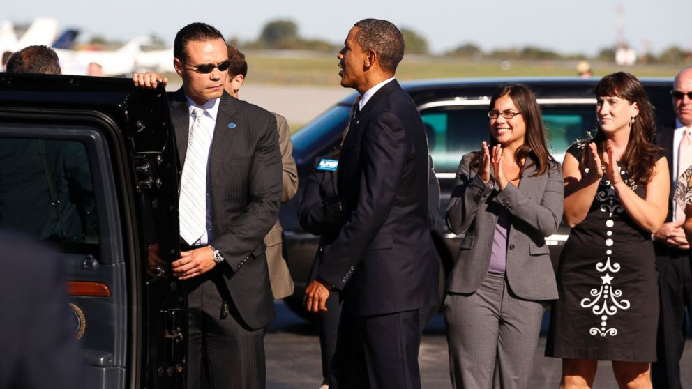 Bongino (left) escorts President Obama into his vehicle.